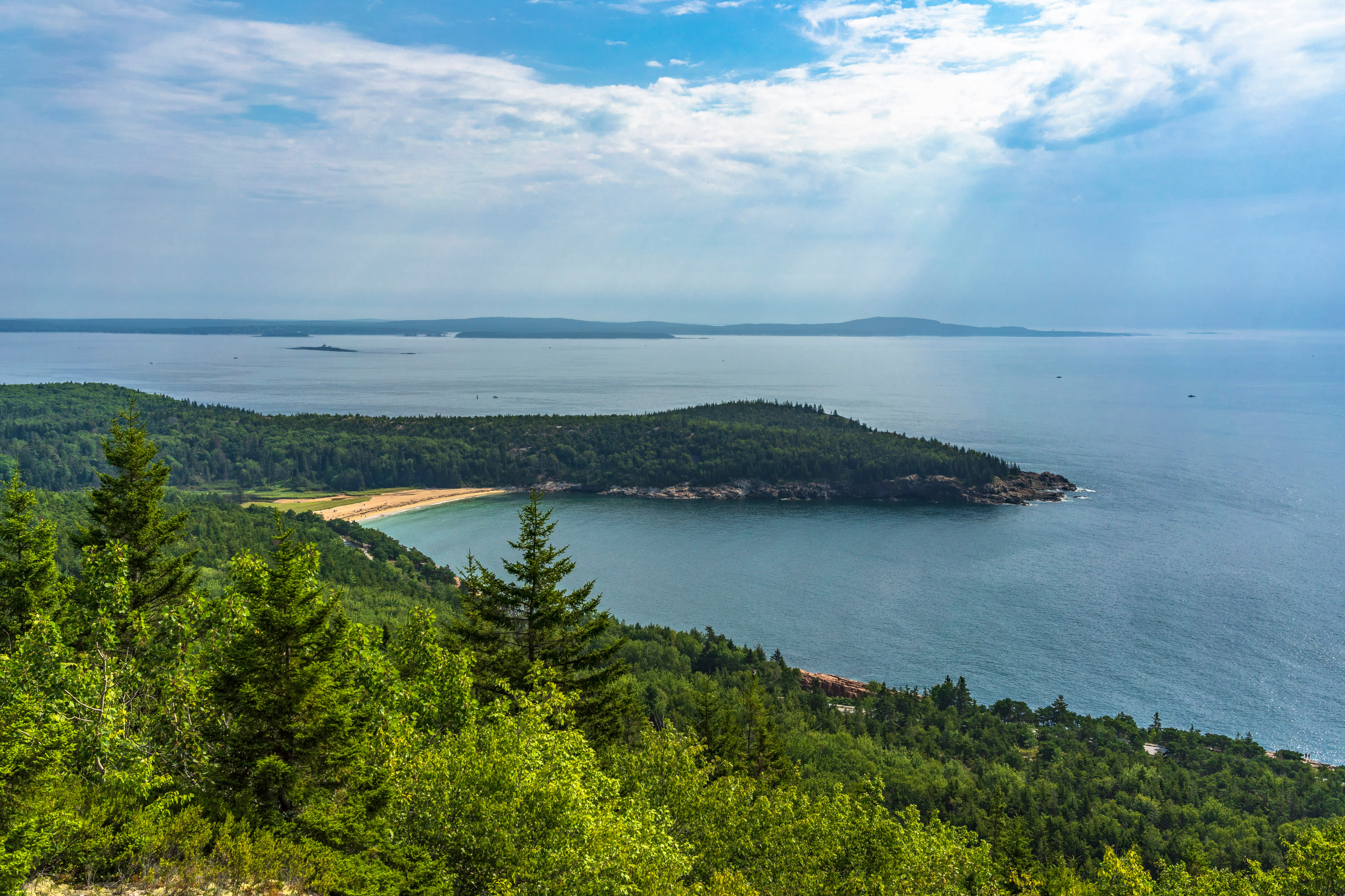 Aerial view of a wooded Maine lake shoreline