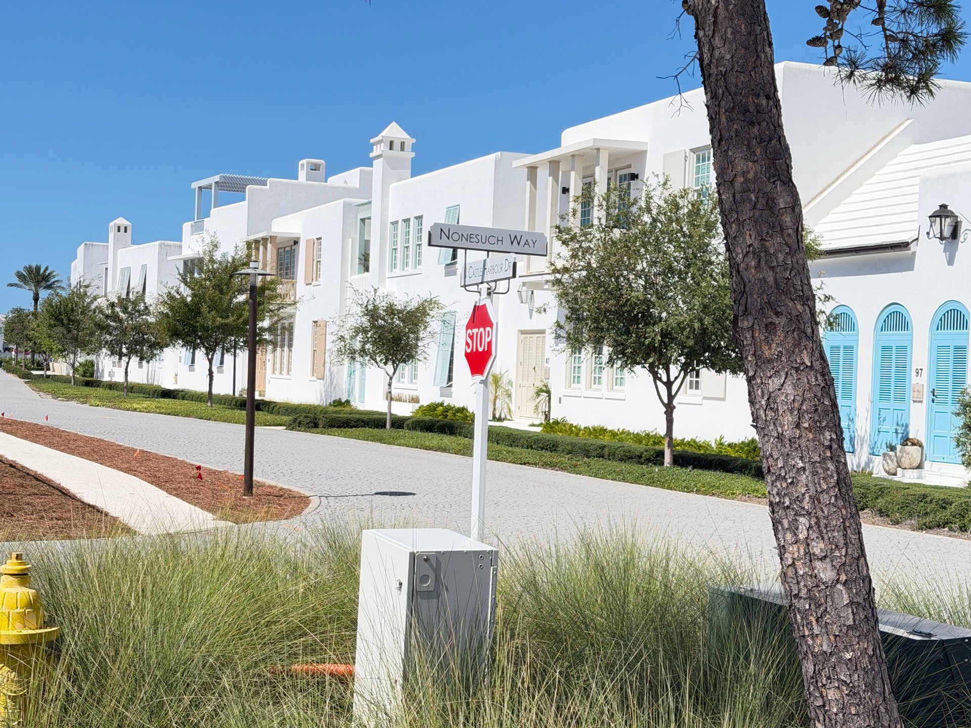Nonesuch Way street sign with white luxury homes in Alys Beach Florida