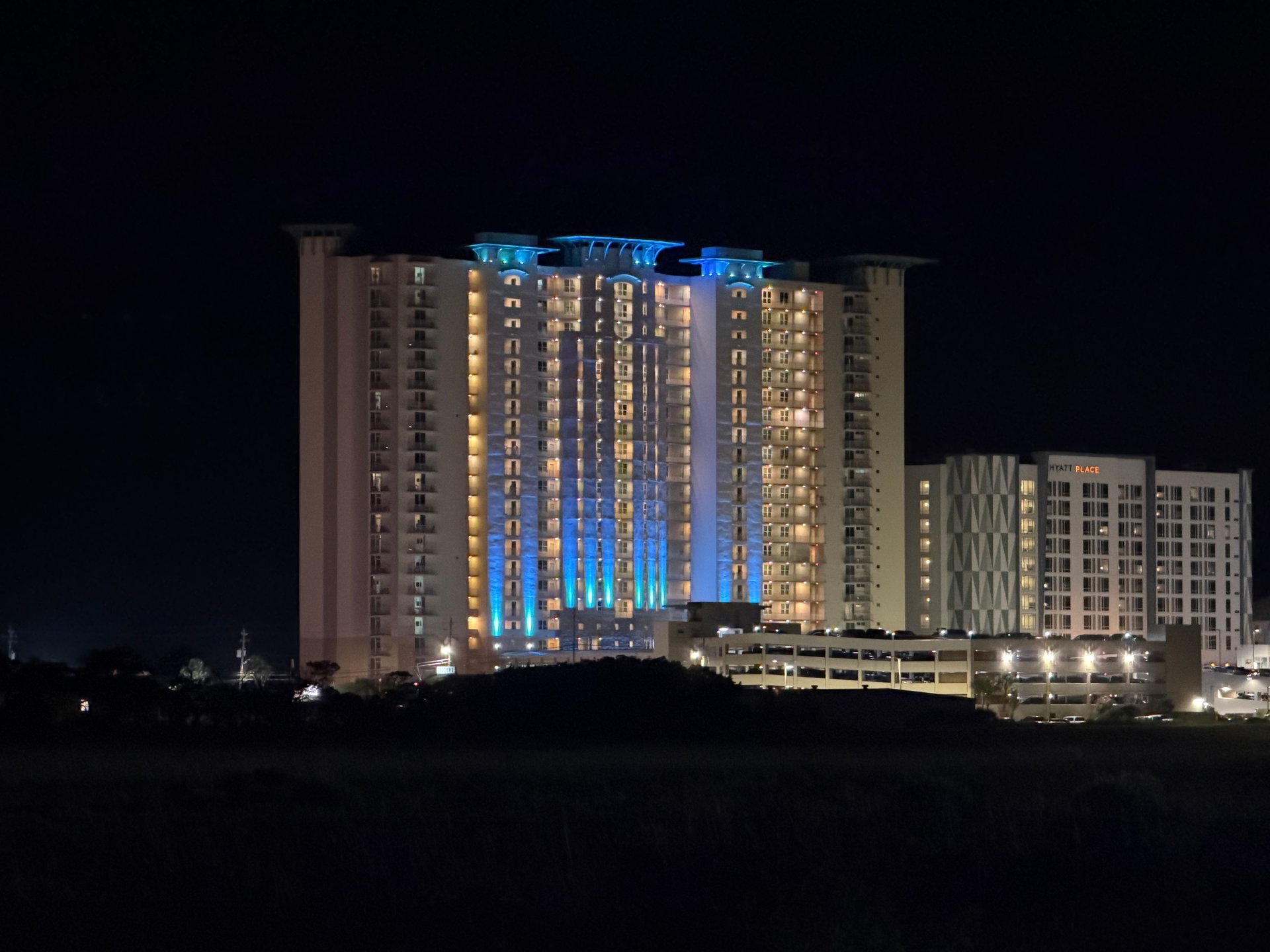 Panama City Beach resort condominium at night with parking and guest amenities