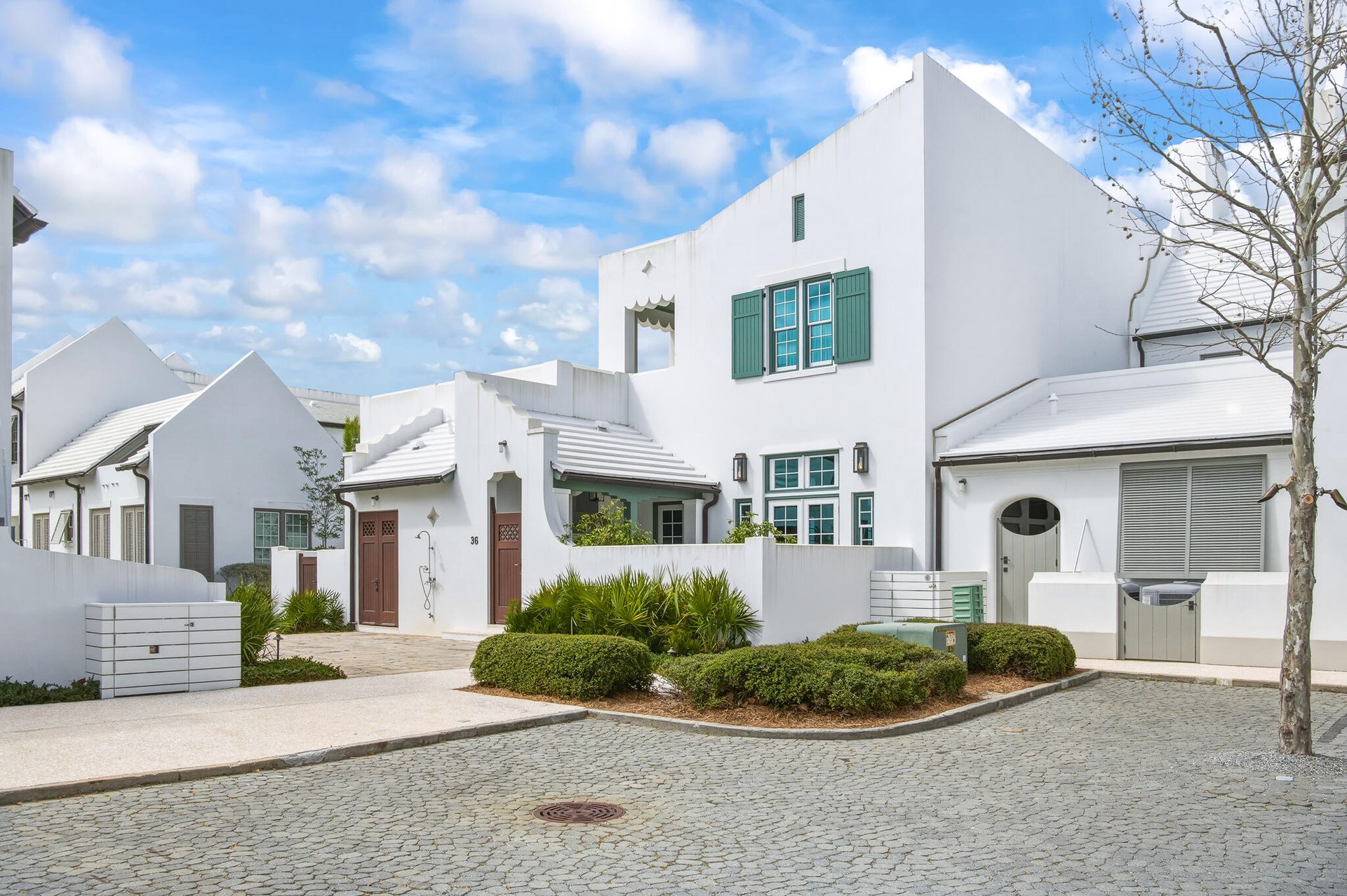 White Alys Beach home with courtyard walls and Bermuda-inspired architecture