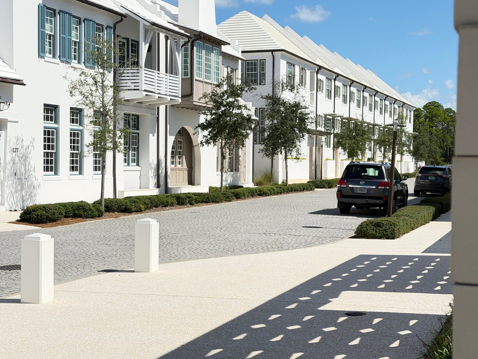 Finished white luxury homes and cobblestone street in Alys Beach Florida