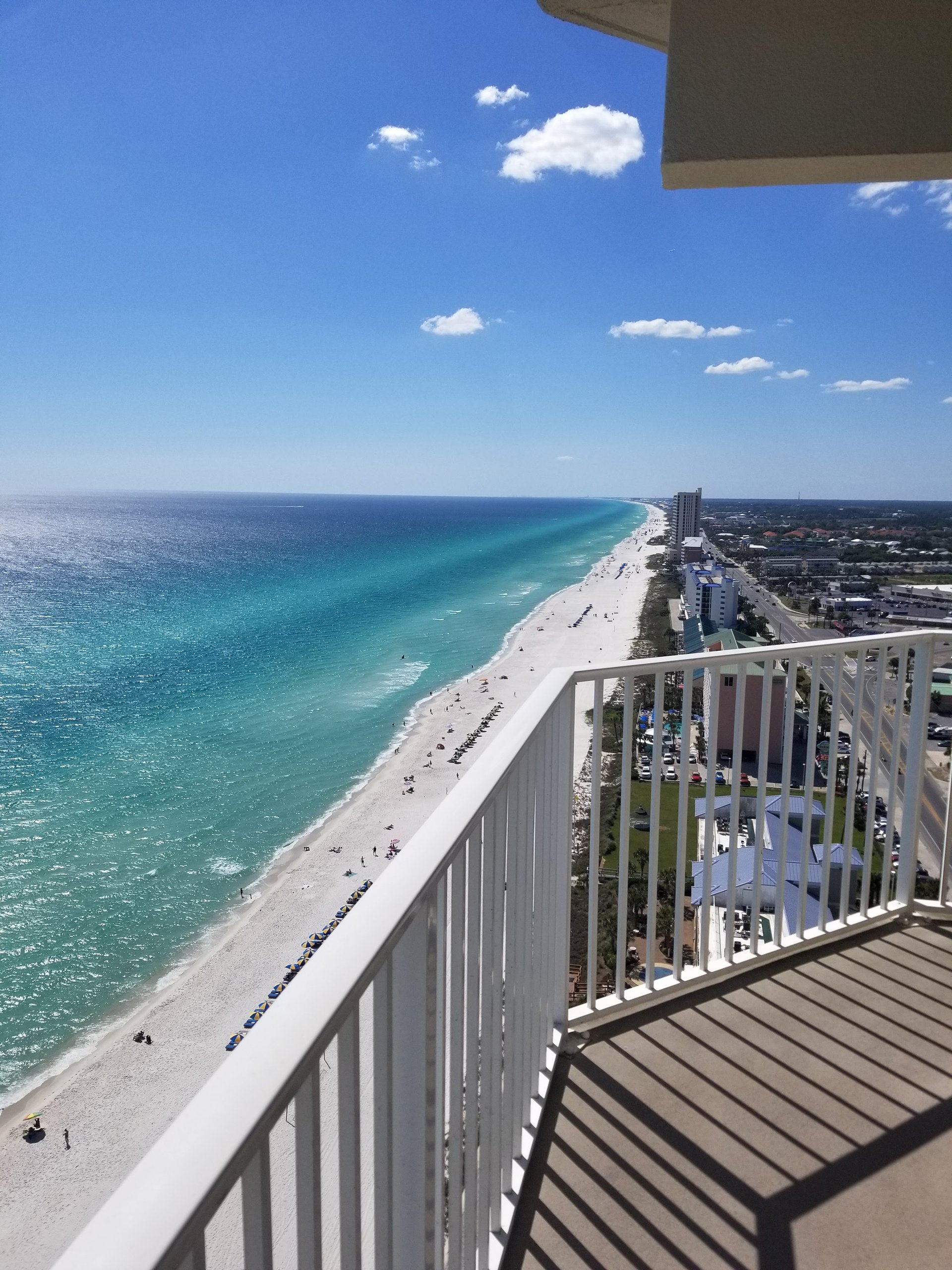 High-floor balcony view of the beach and Gulf-front condominiums in Panama City Beach