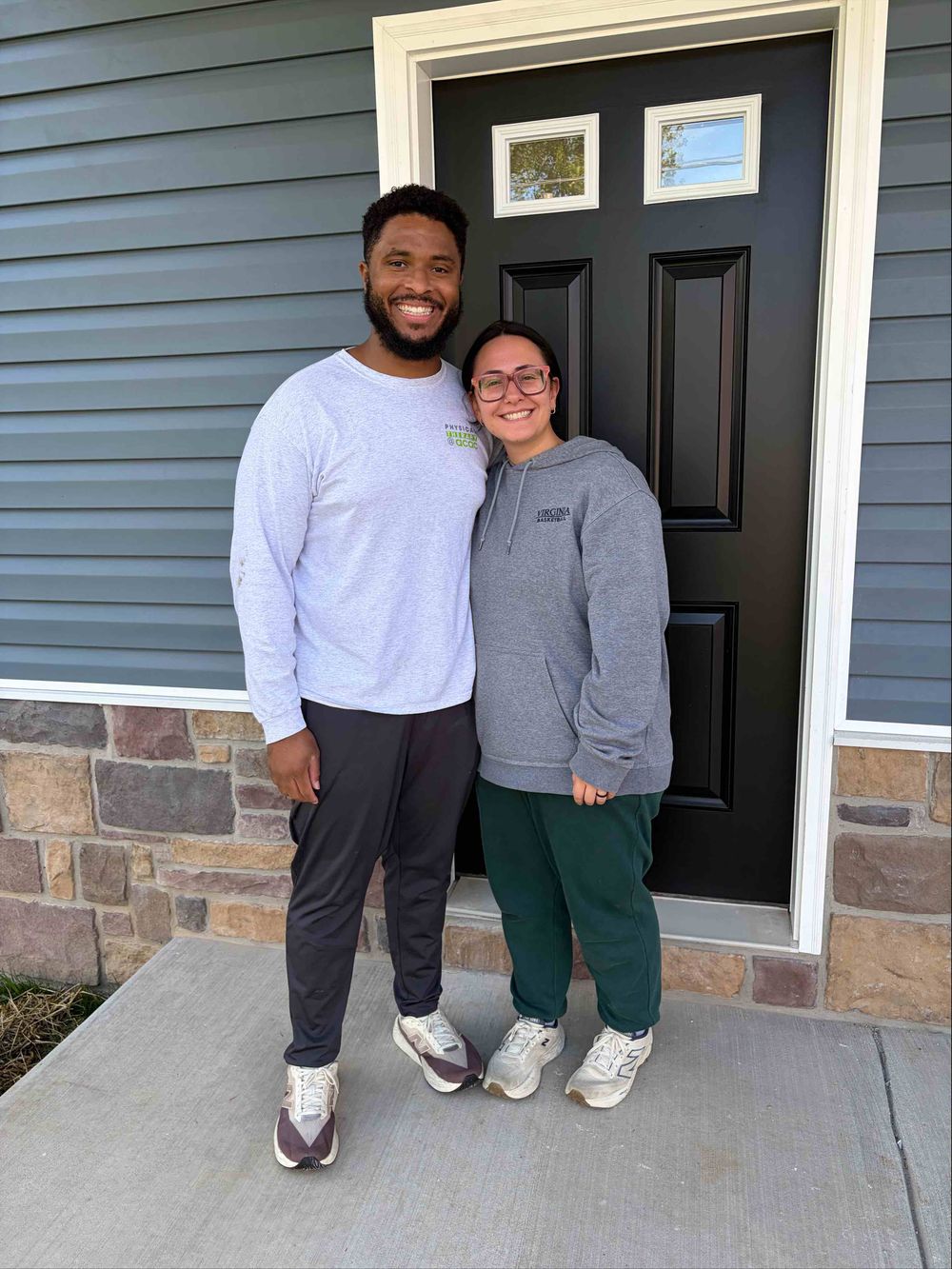 Terius and Courtney at the front door of their new home