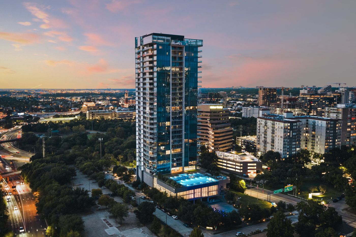 Aerial view of Bleu Ciel and its pool deck at dusk in the Harwood District, Dallas