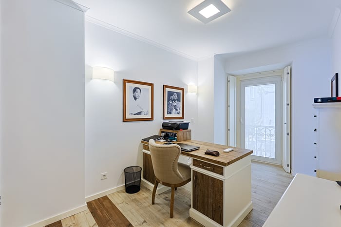 Study with fitted desk and balcony door