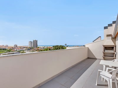 A rooftop terrace with a built-in grill, looking out toward the Atlantic