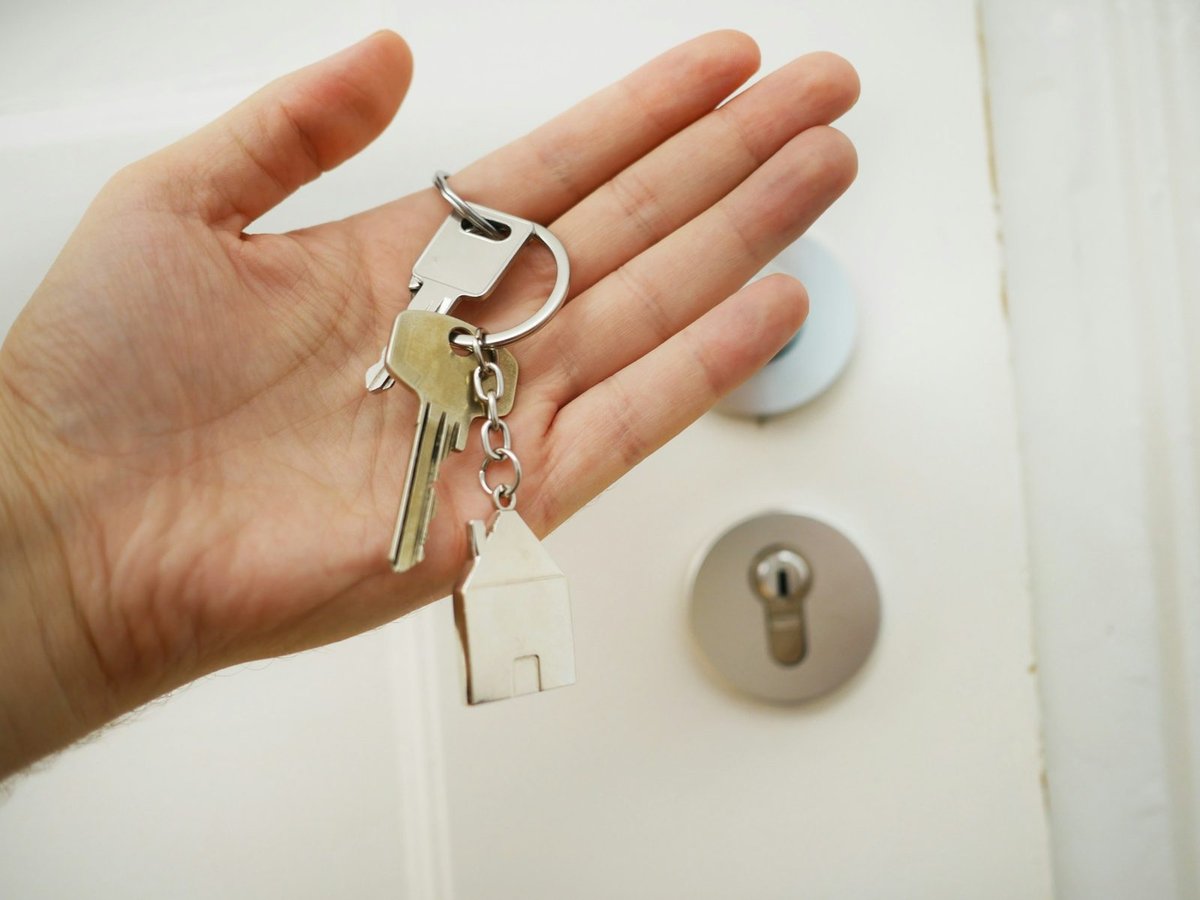 Handing over house keys after a home sale