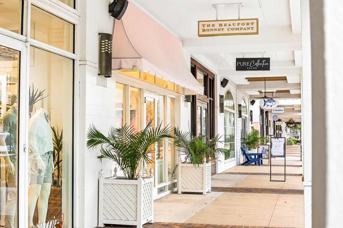 Covered shopping walkway at Grand Boulevard at Sandestin with boutique storefronts in Miramar Beach, Florida