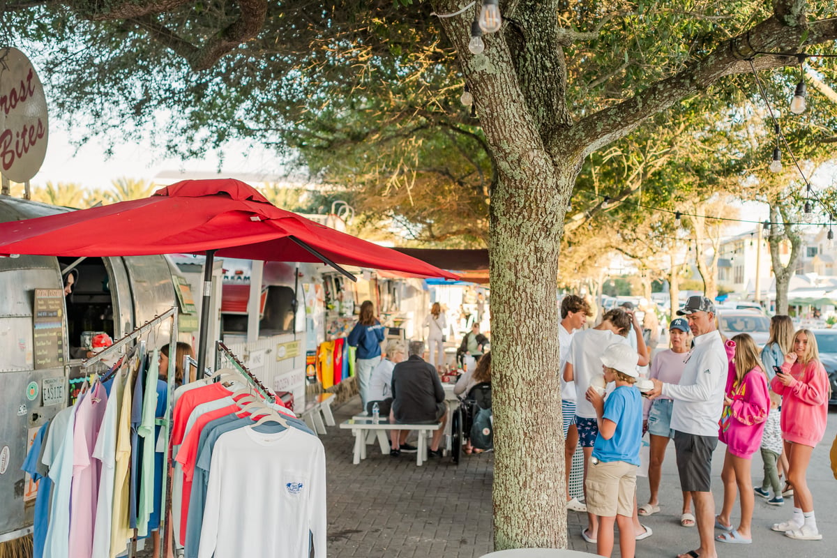 Families gathered under the oaks at the Airstream Row food trucks in Seaside, Florida, on a fall evening
