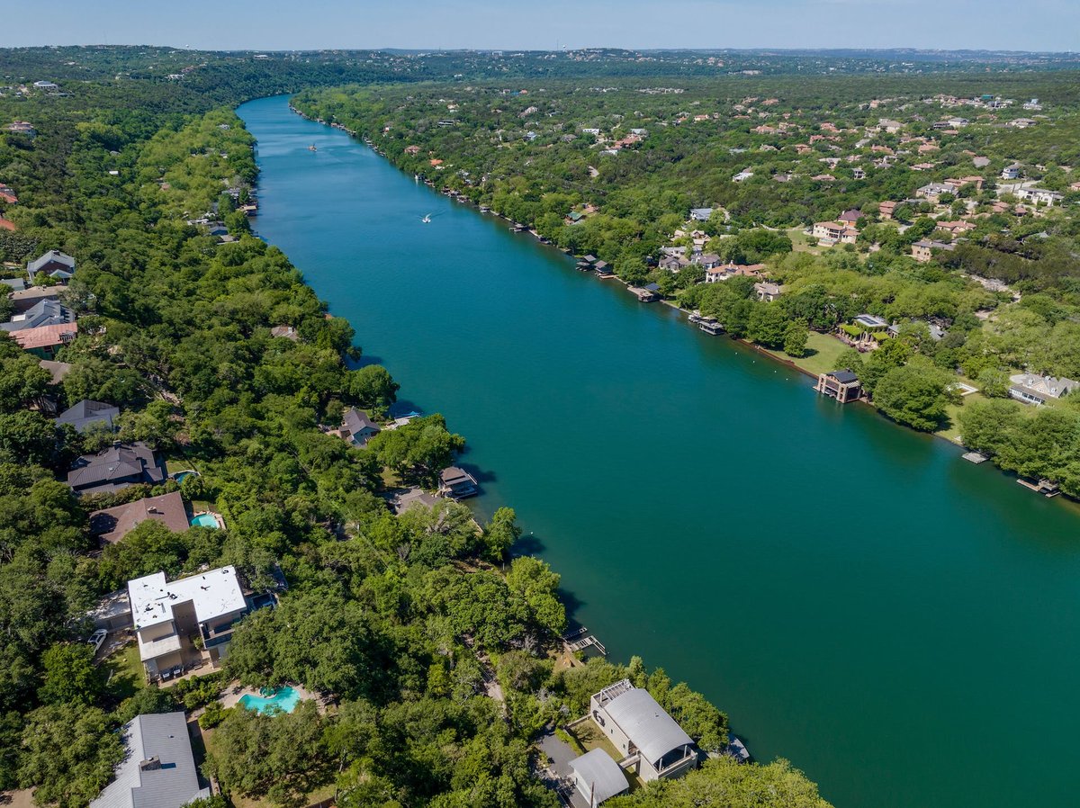 Lake Austin shoreline with limestone cliffs and waterfront estates near Westlake Drive