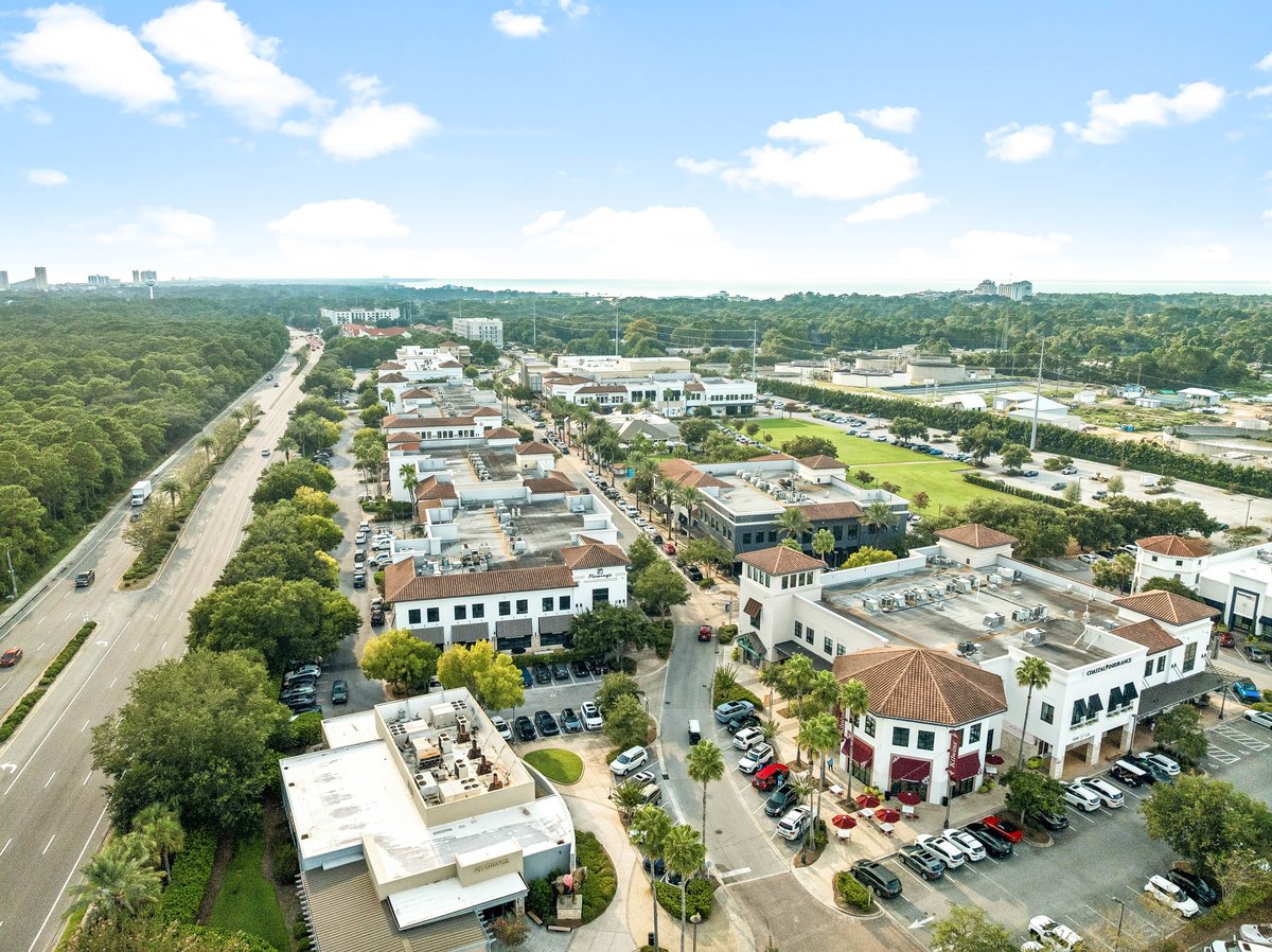 Aerial of Miramar Beach Florida showing Grand Boulevard town center, Highway 98, and the Gulf coastline