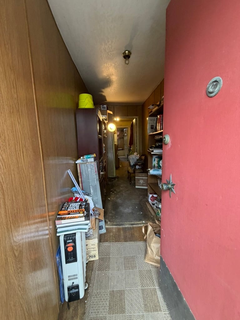 View through the front door of 964-966 York Street, hallway still full of the previous owner's belongings, Mission District San Francisco