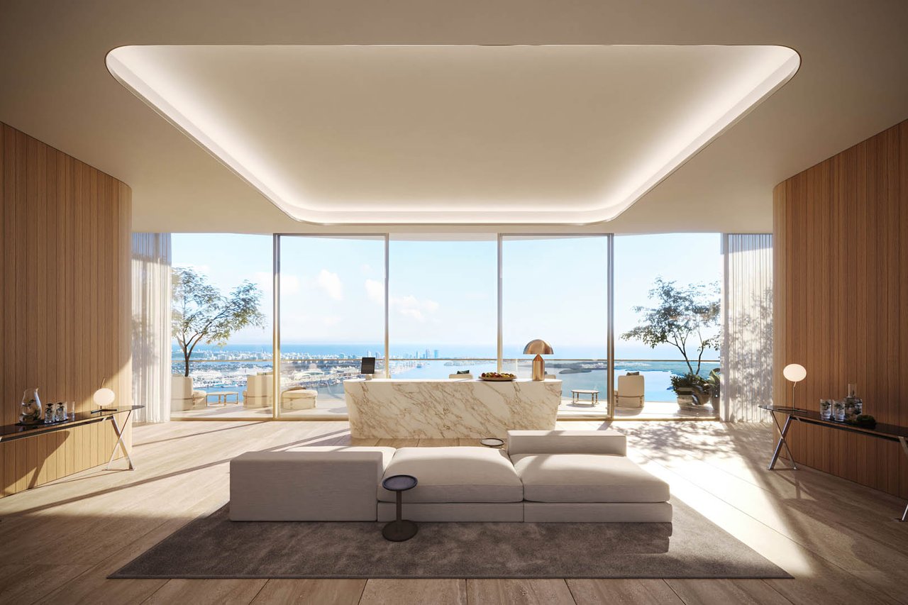 Living room with a marble console and floor-to-ceiling windows overlooking water and the Miami skyline.