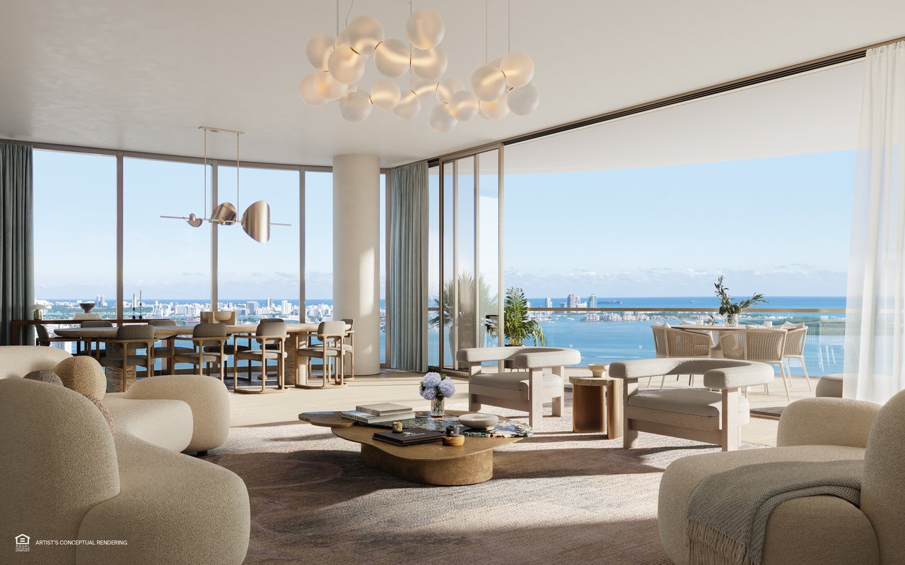 Living and dining room with floor-to-ceiling windows overlooking Biscayne Bay and the Miami skyline.