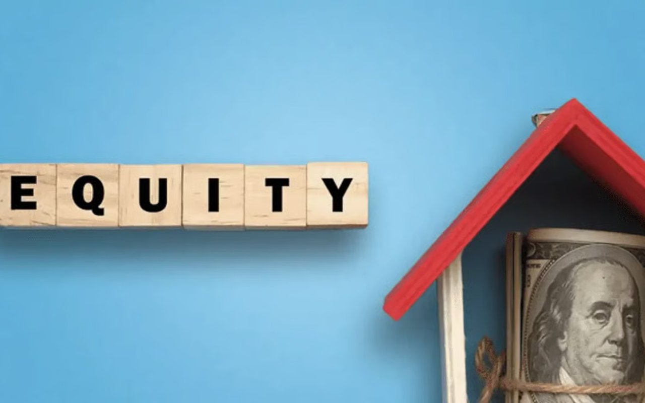 Wooden tiles spelling “EQUITY” beside a miniature house roof and a $100 bill.