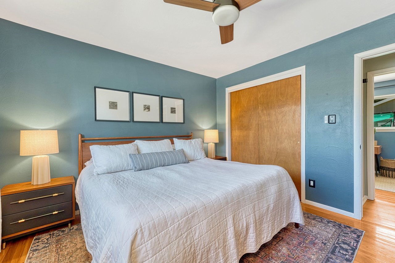 Primary bedroom with a double closet and hardwood floors