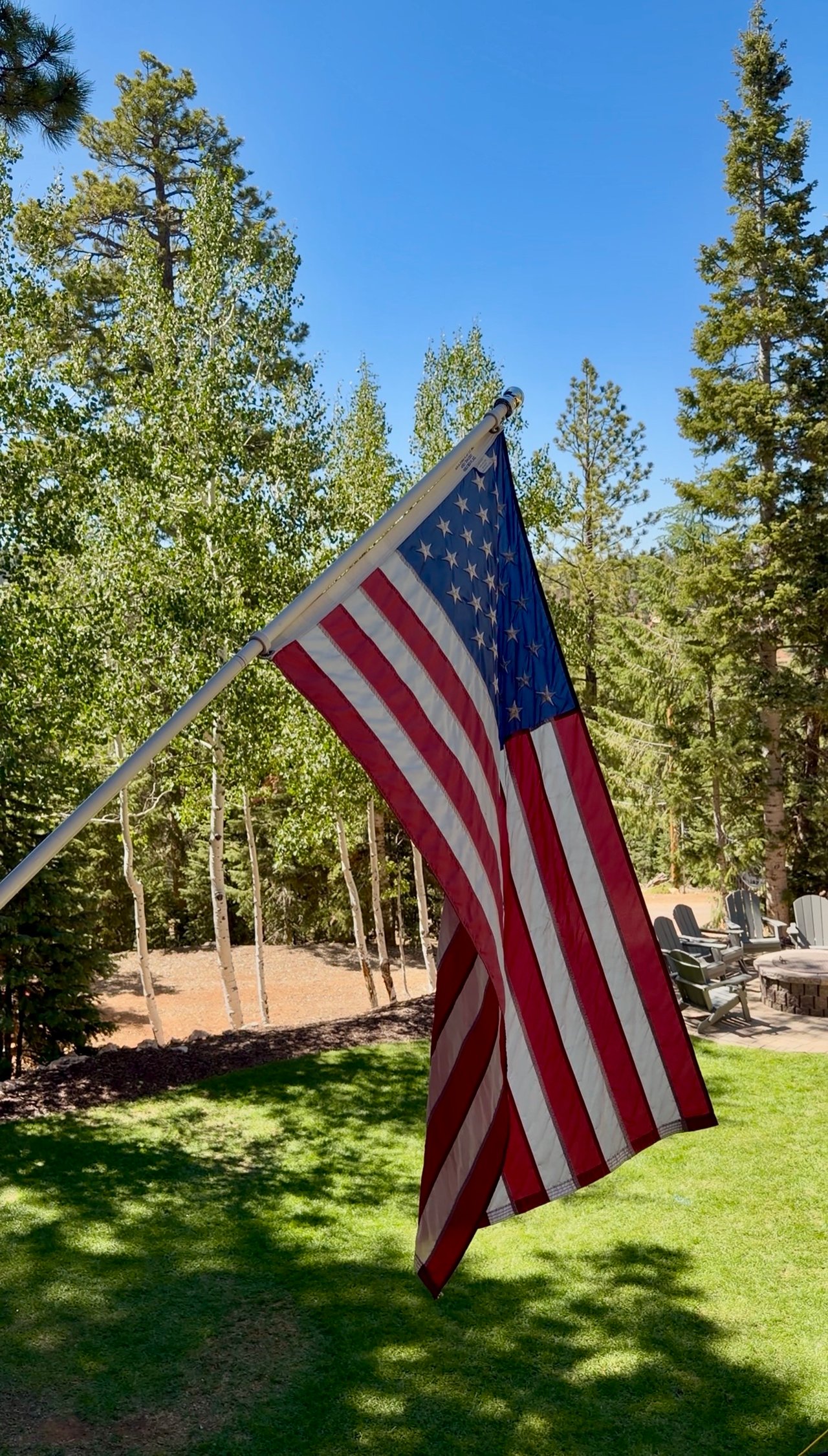 American flag flying over a Utah County backyard on a clear day, honoring community and remembrance
