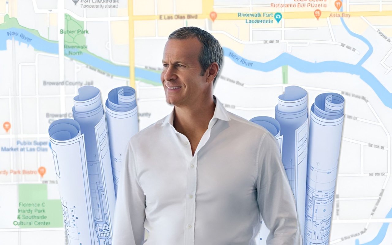 Developer Vladislav Doronin in a white shirt, with architectural plans and a Fort Lauderdale map behind him.