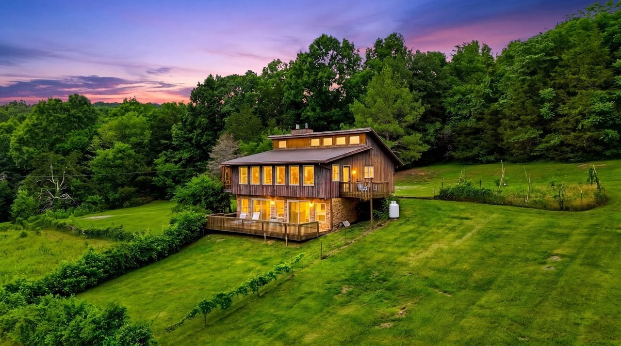Aerial view of the private 100-acre estate at 427 Adams Rd in Watertown, Tennessee, featuring a charming country home surrounded by rolling hills, mature woodlands, scenic water features, and expansive countryside just outside Nashville.