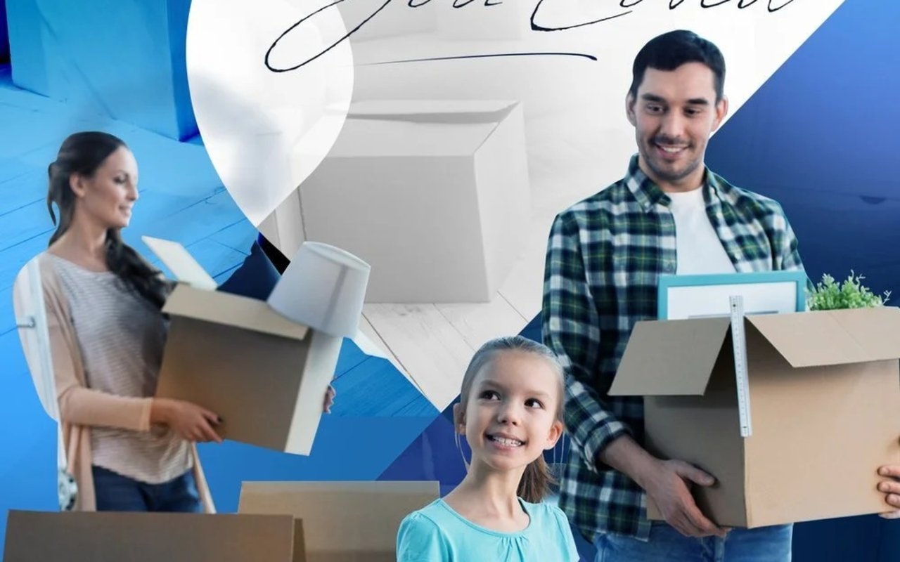 A family with moving boxes, including a smiling girl in front.