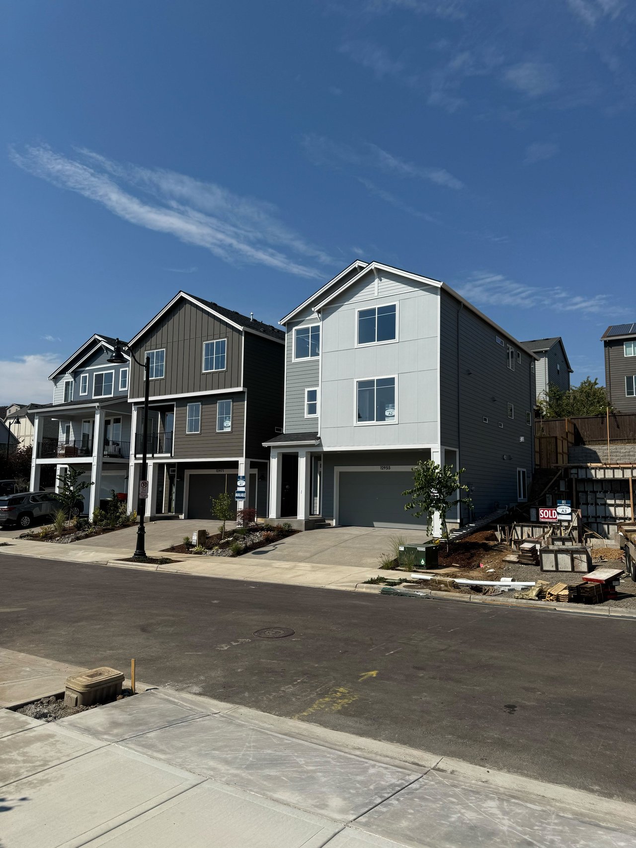 Front view of a three-story modern new construction home at Deer Fern Ridge in Bethany, Oregon, showcasing smart design and energy-efficient features