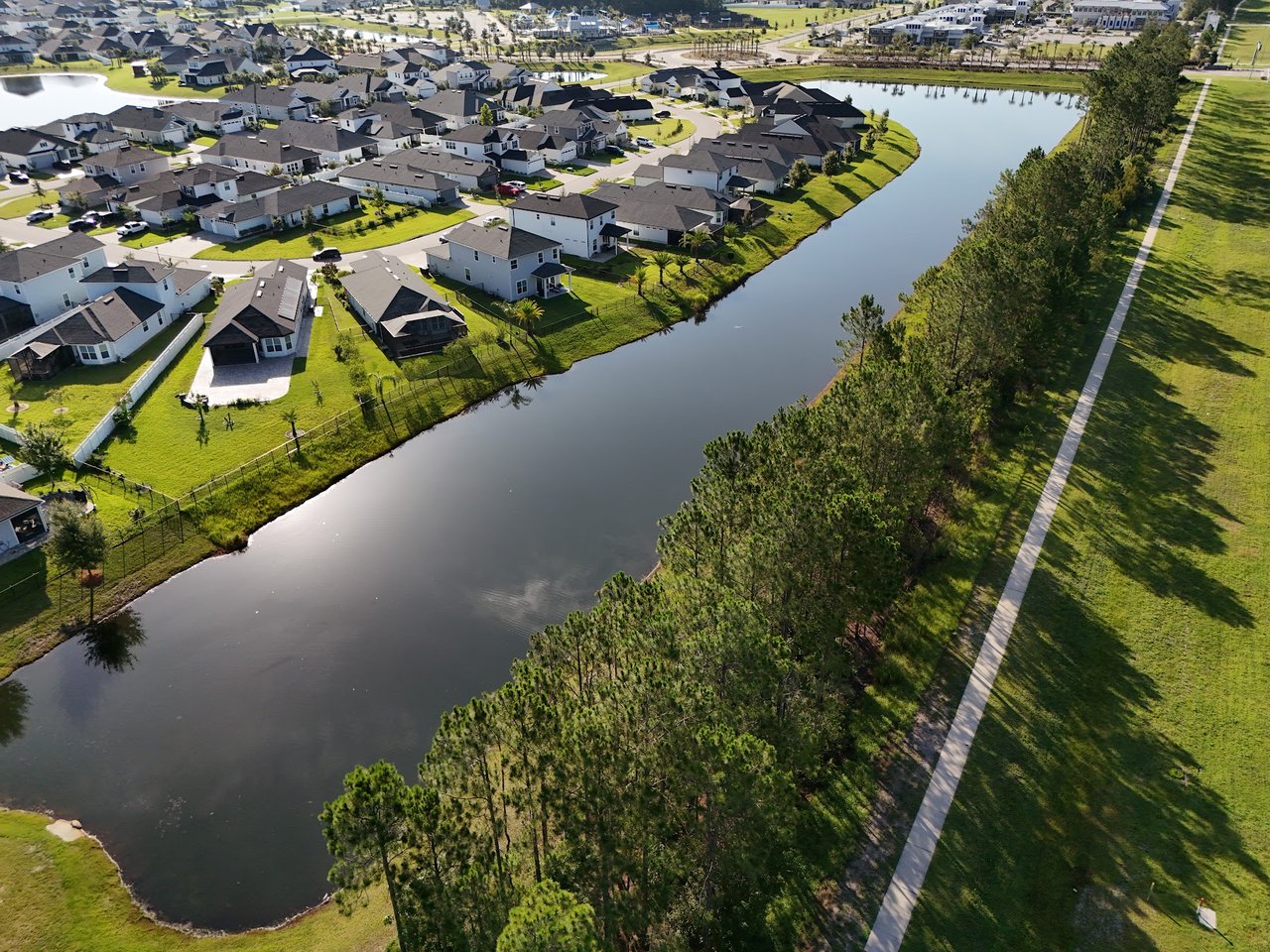 Aerial view of homes along a pond in Silverleaf Village