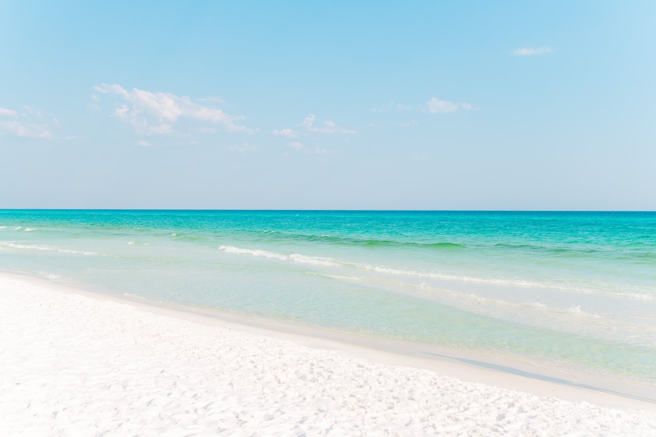 Pristine sugar-white sand meeting the calm turquoise-to-emerald Gulf of Mexico at Blue Mountain Beach on 30A, Florida