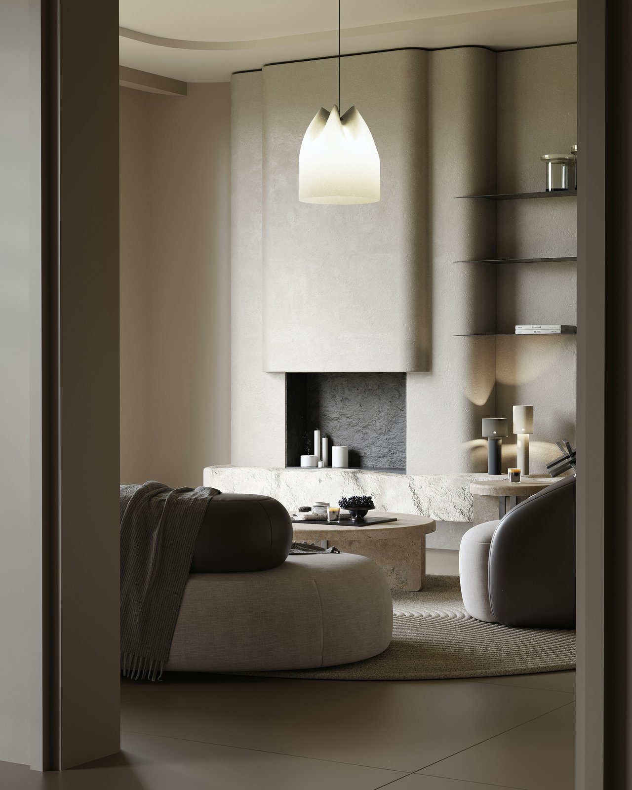 Staged living room with a sculptural stone fireplace, curved sofas, and a glowing pendant light.
