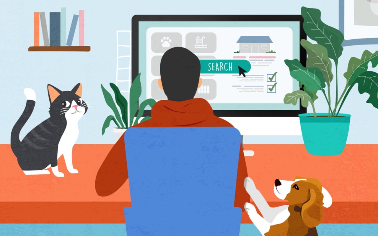 Person searches for a home online with a cat and dog nearby.