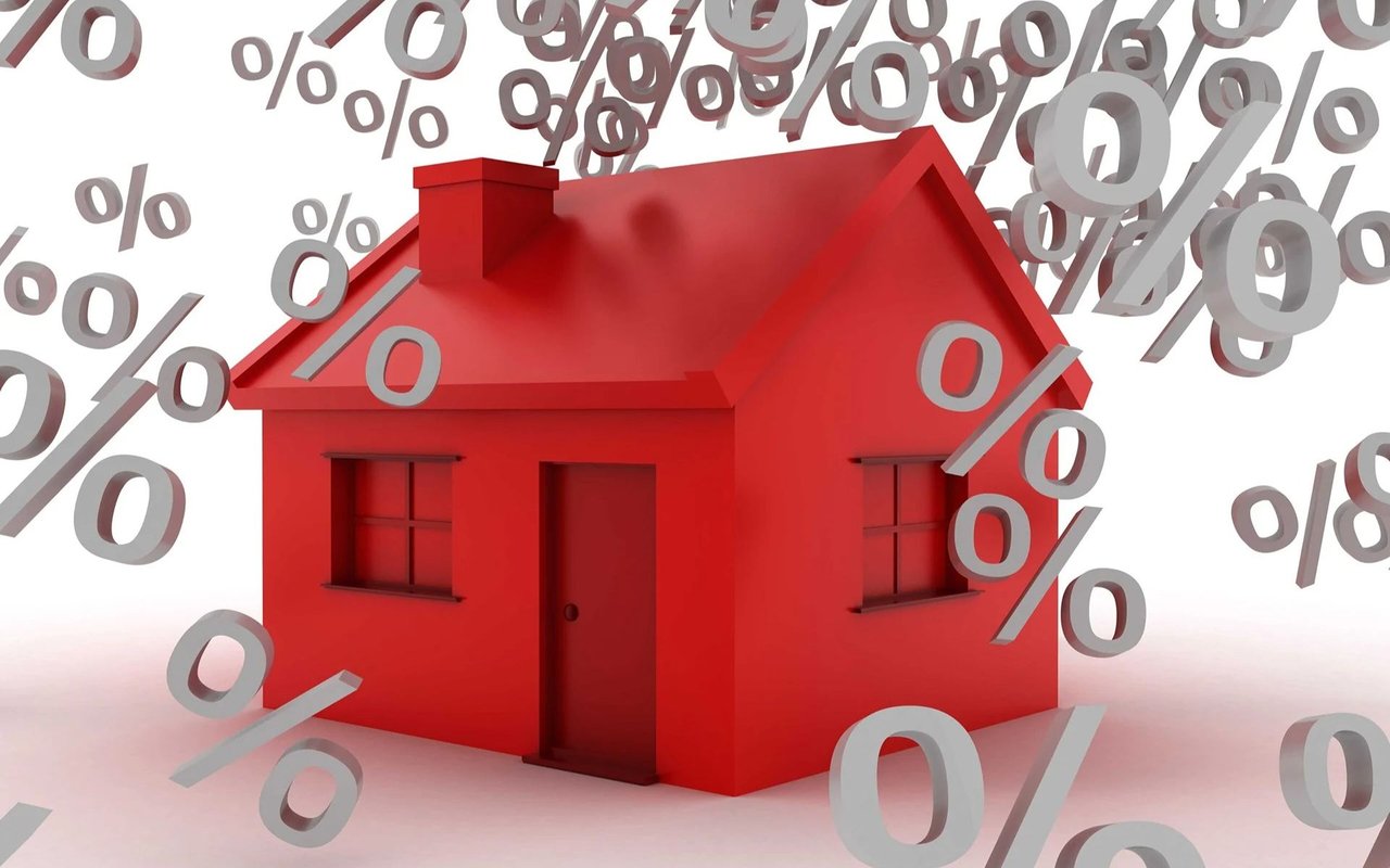 Red house surrounded by floating percent signs.