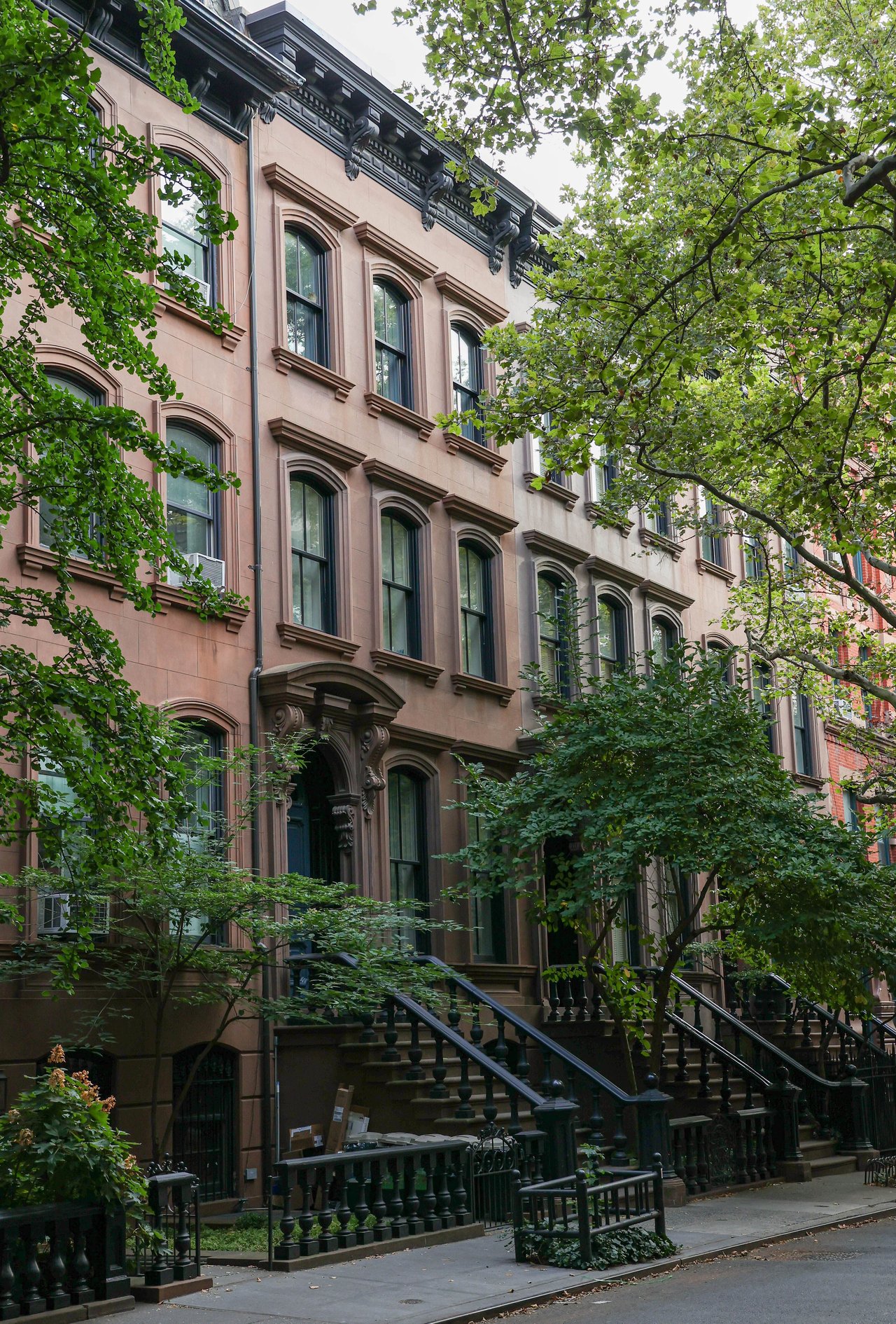 Historic brownstones, tree-lined blocks, signature front gardens, and boutique condominiums along Carroll Street in Carroll Gardens, Brooklyn.