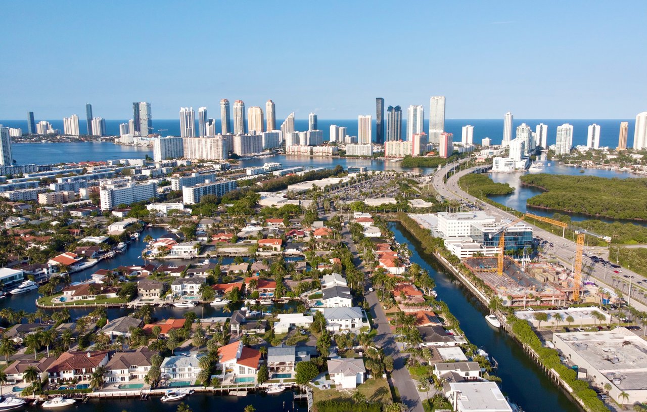 Aerial view of Eastern Shores waterfront homes, canals, and 163rd Street corridor in North Miami Beach