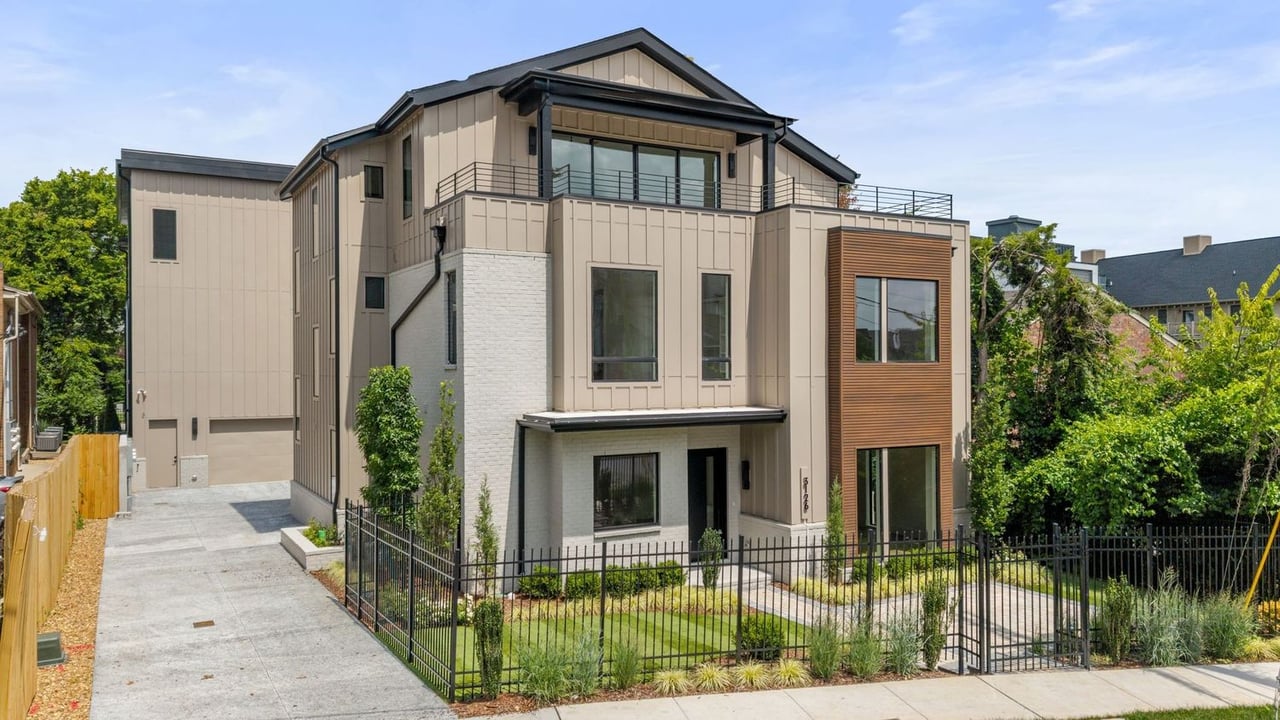 Front exterior of the modern luxury home at 3126 Belwood St, Nashville, TN 37203, featuring contemporary architecture, clean lines, expansive windows, premium exterior finishes, a landscaped front yard, and a private fenced entrance in one of Nashville's desirable residential neighborhoods.