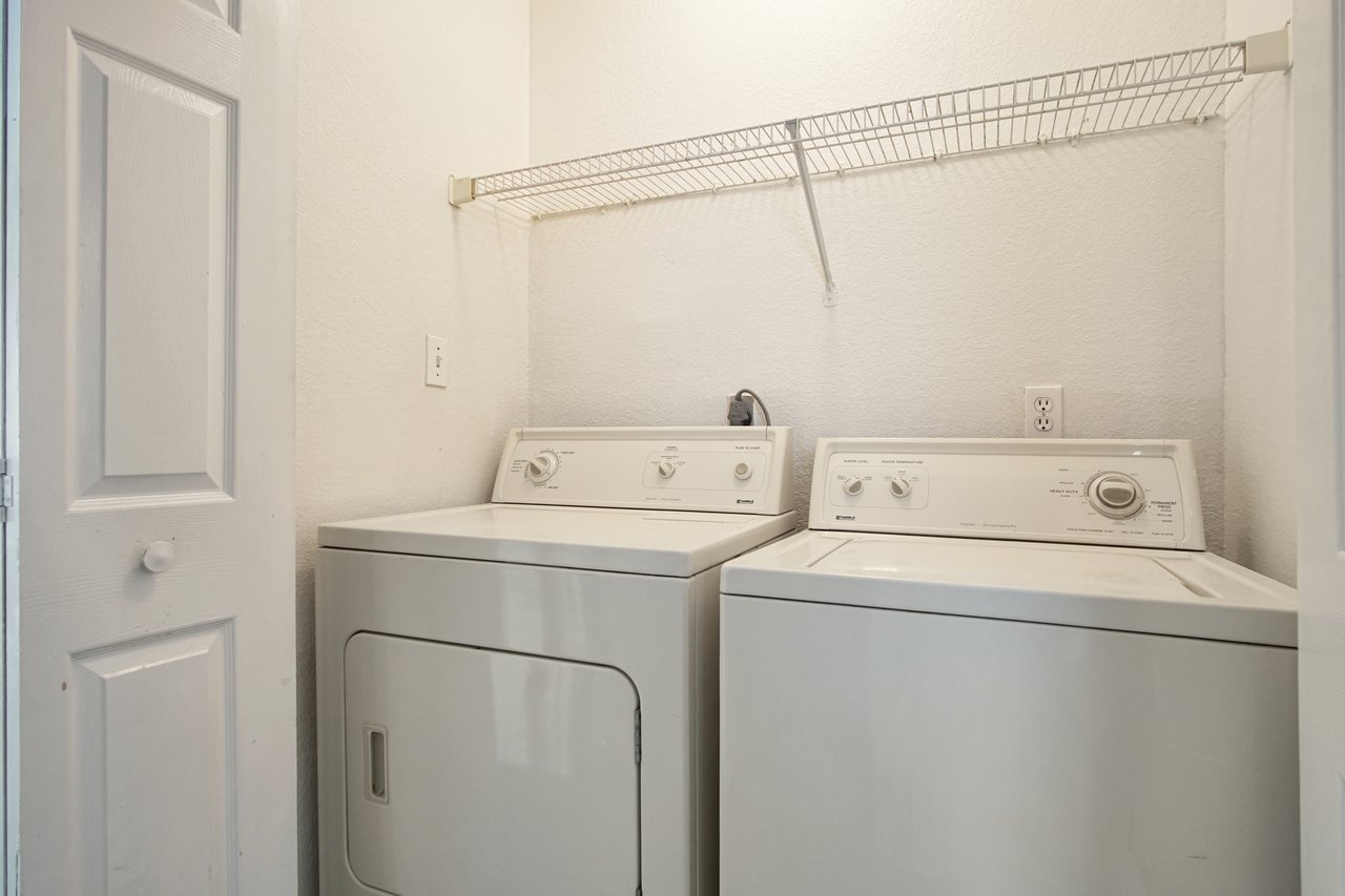 A laundry room featuring a washer and dryer, organized and ready for use.