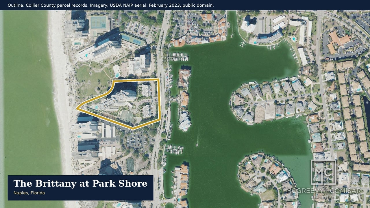 Aerial map of The Brittany at Park Shore, outlined beside the Naples beachfront and marina.