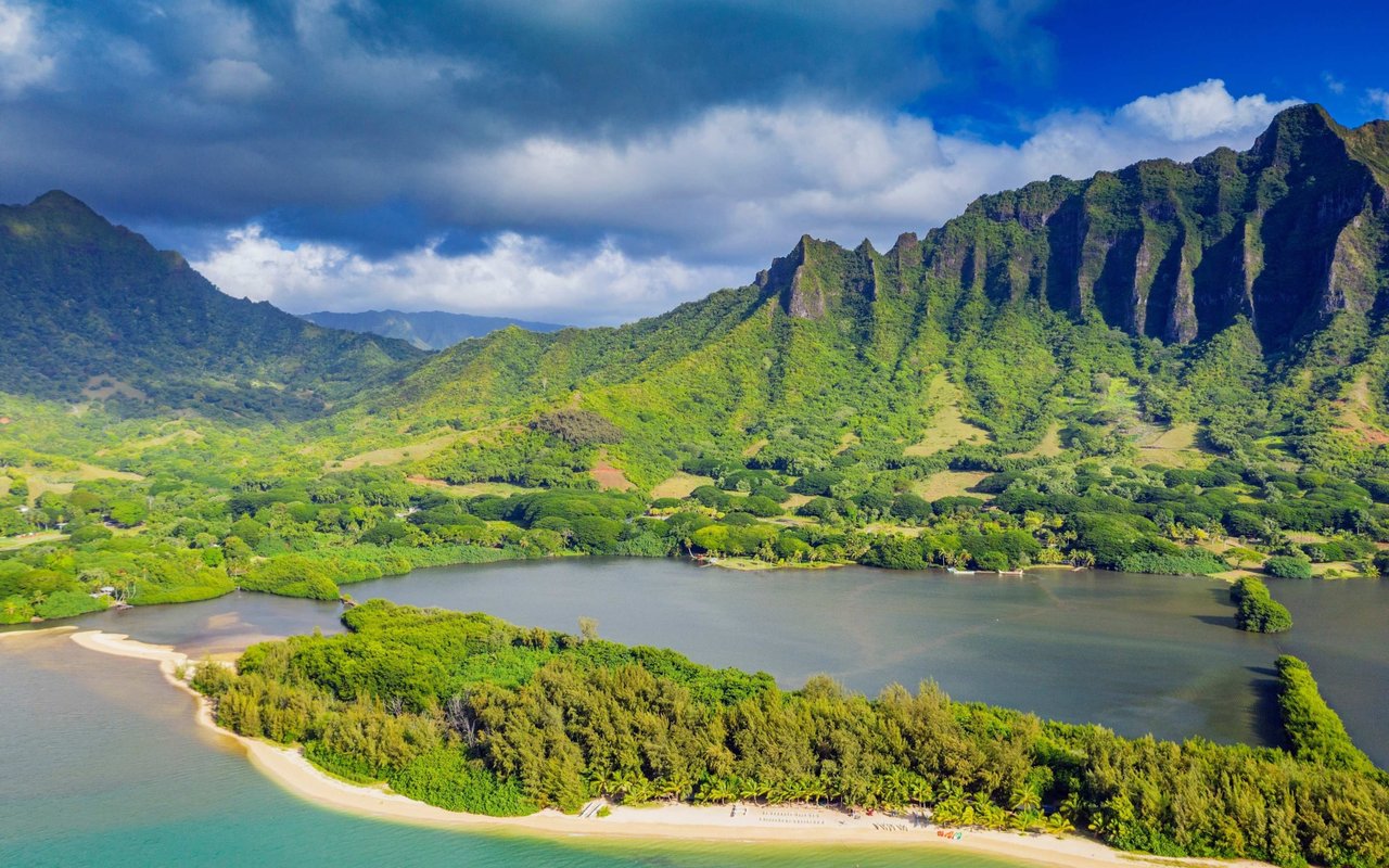 Kaneohe shoreline and calm waters beneath the lush, jagged Koʻolau mountains.