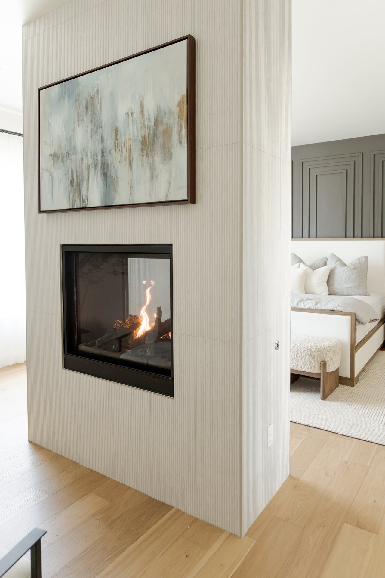 Stunning fireplace in the primary suite of a luxury Edmond home, featuring custom built-ins, soft neutral tones, and cozy lighting that create a serene, retreat-like atmosphere.