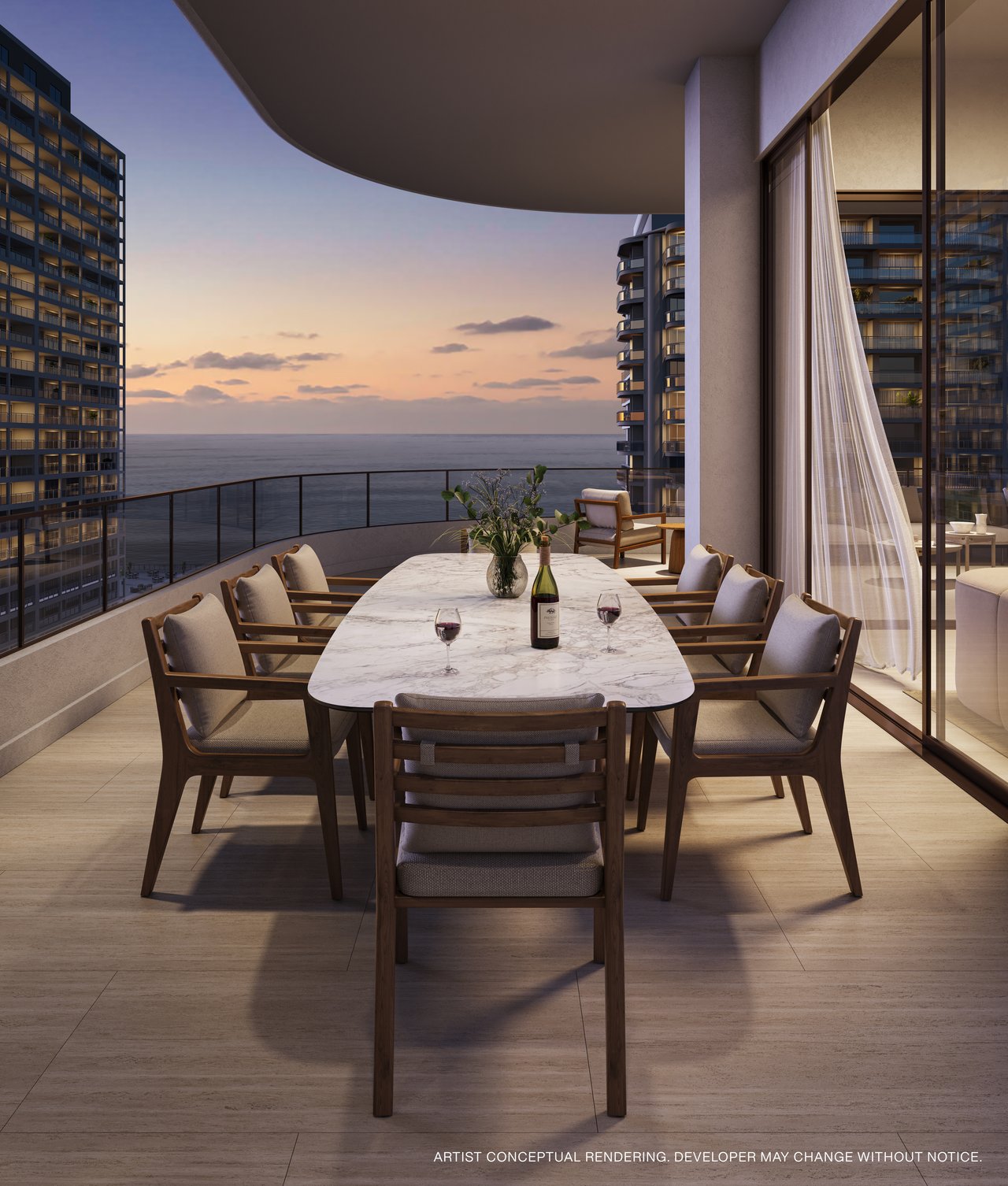 Furnished oceanfront balcony with a dining table, neighboring towers, and sunset views.