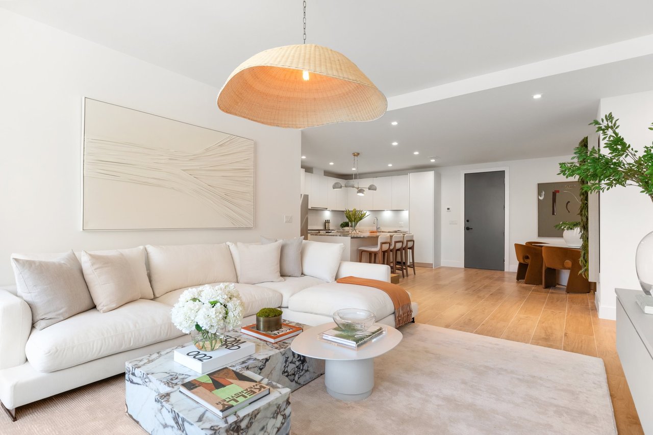 Arbor Coconut Grove residence living room with sectional sofa and open dining area