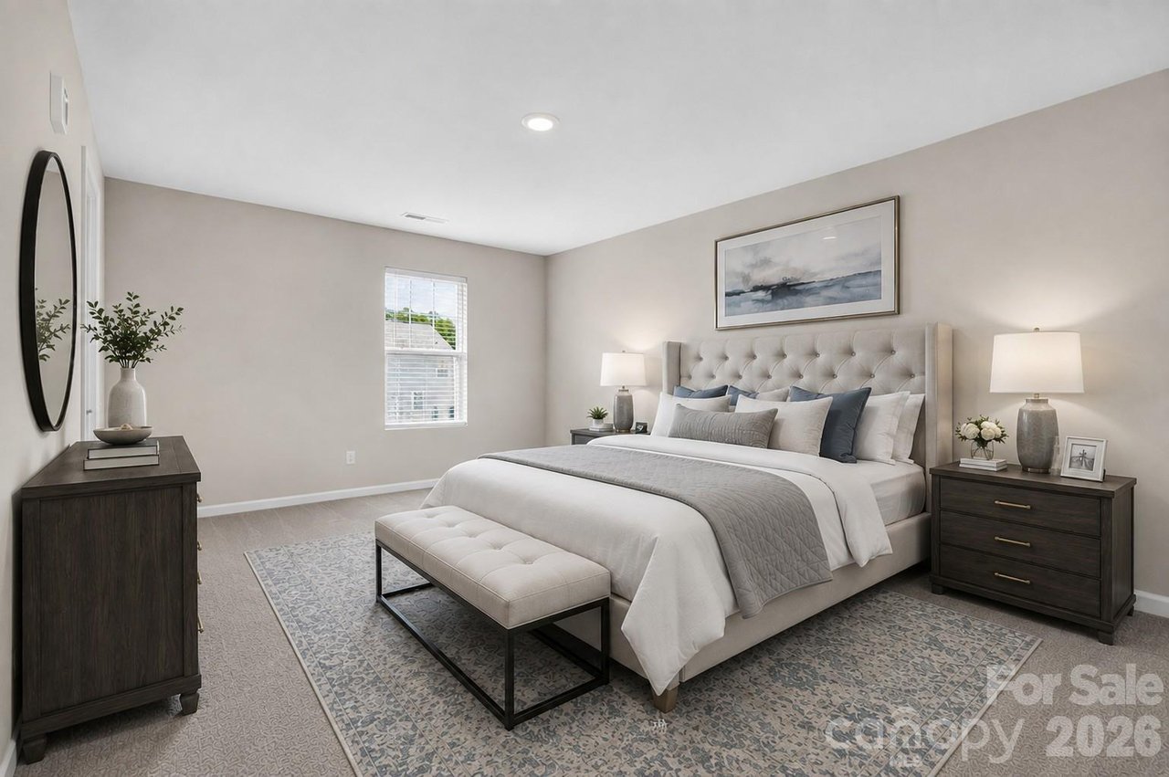 Staged bedroom with a tufted bed, matching bench, dark wood nightstands, and patterned rug.