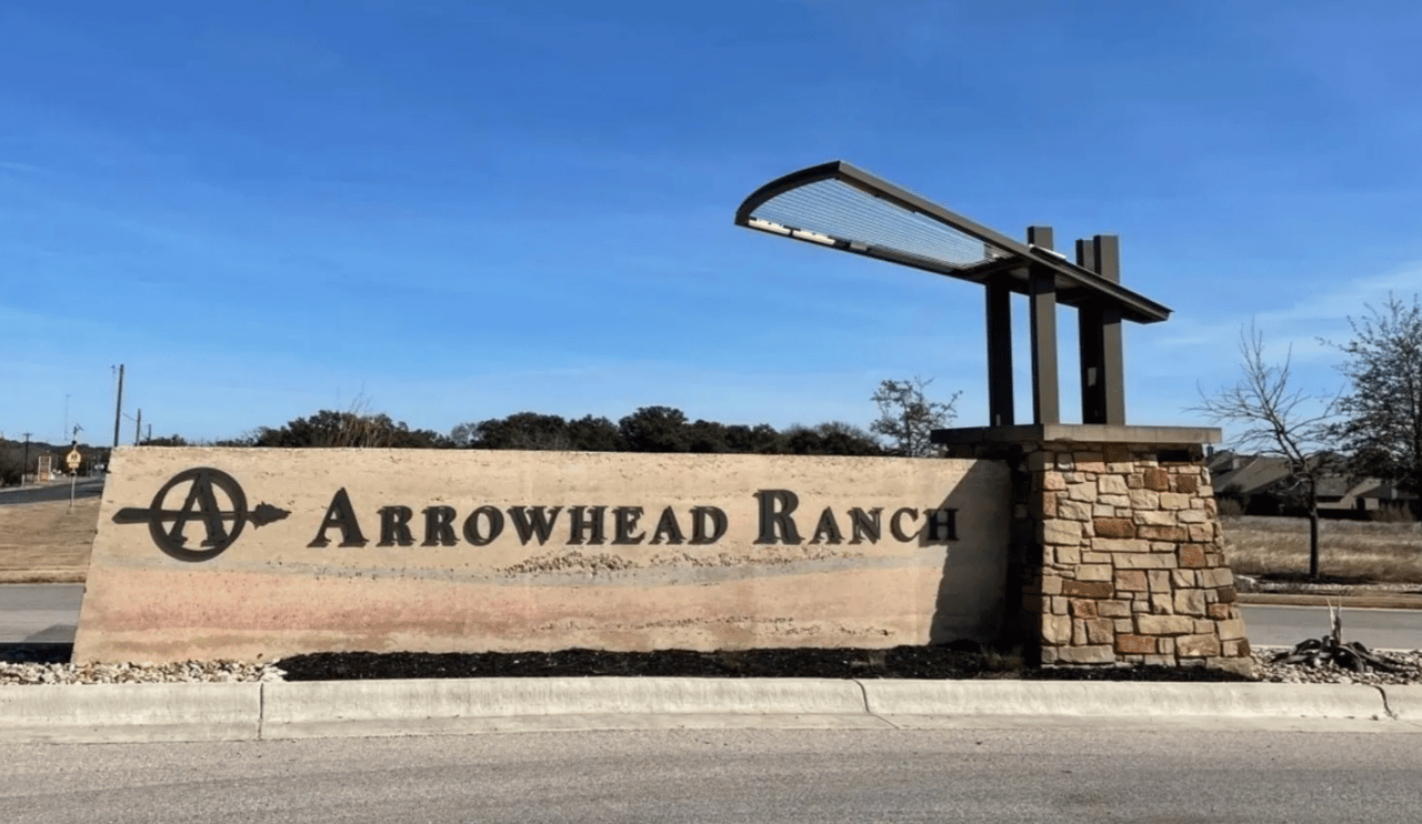 Arrowhead Ranch entrance sign with a stone base and modern metal canopy.