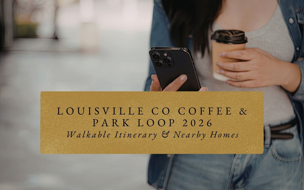 Person carrying a to-go coffee cup walking past brick storefronts on a sunny morning in downtown Louisville Colorado