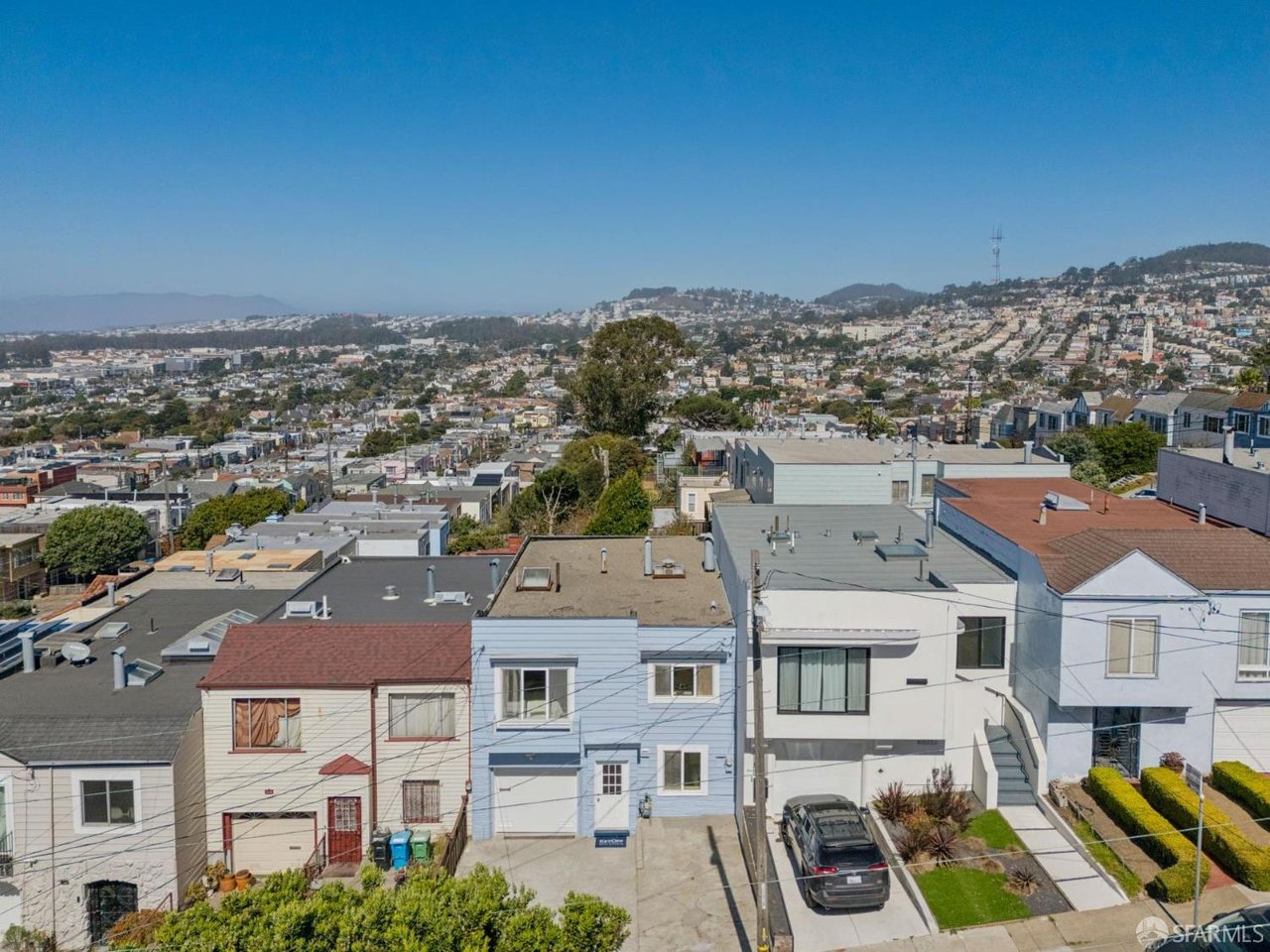Elevated view over San Francisco homes toward the city’s hills.
