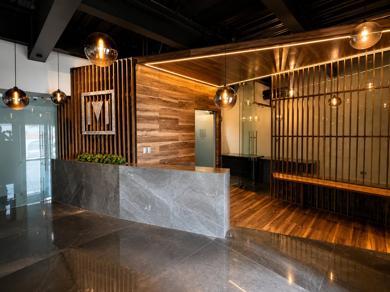 Corporate office reception with a marble desk, wood-paneled walls, and warm pendant lighting.