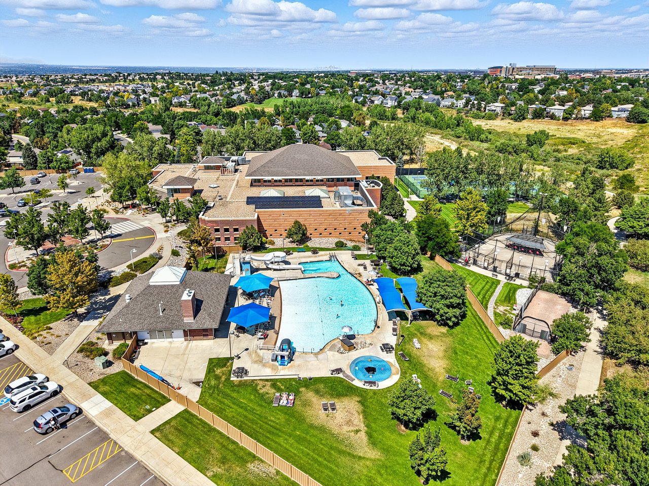 Aerial view of Highlands Ranch, Colorado featuring residential neighborhoods, open space, and mountain views in the distance.