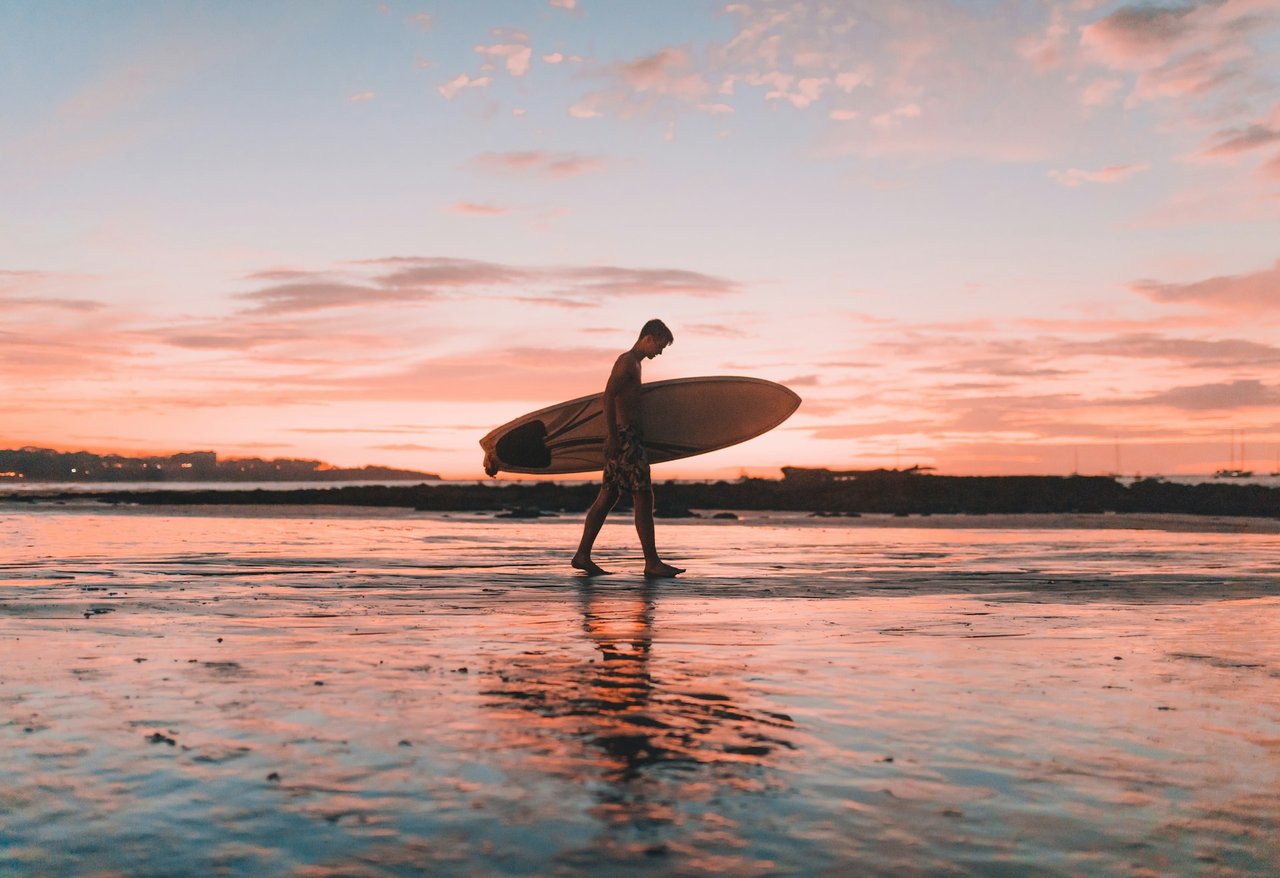 photo of a man surfing in Costa Rica, one of many things to do in Costa Rica