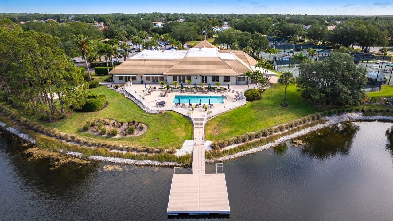 Aerial photo of the Longshore Lake clubhouse and pool along private lake in Naples FL