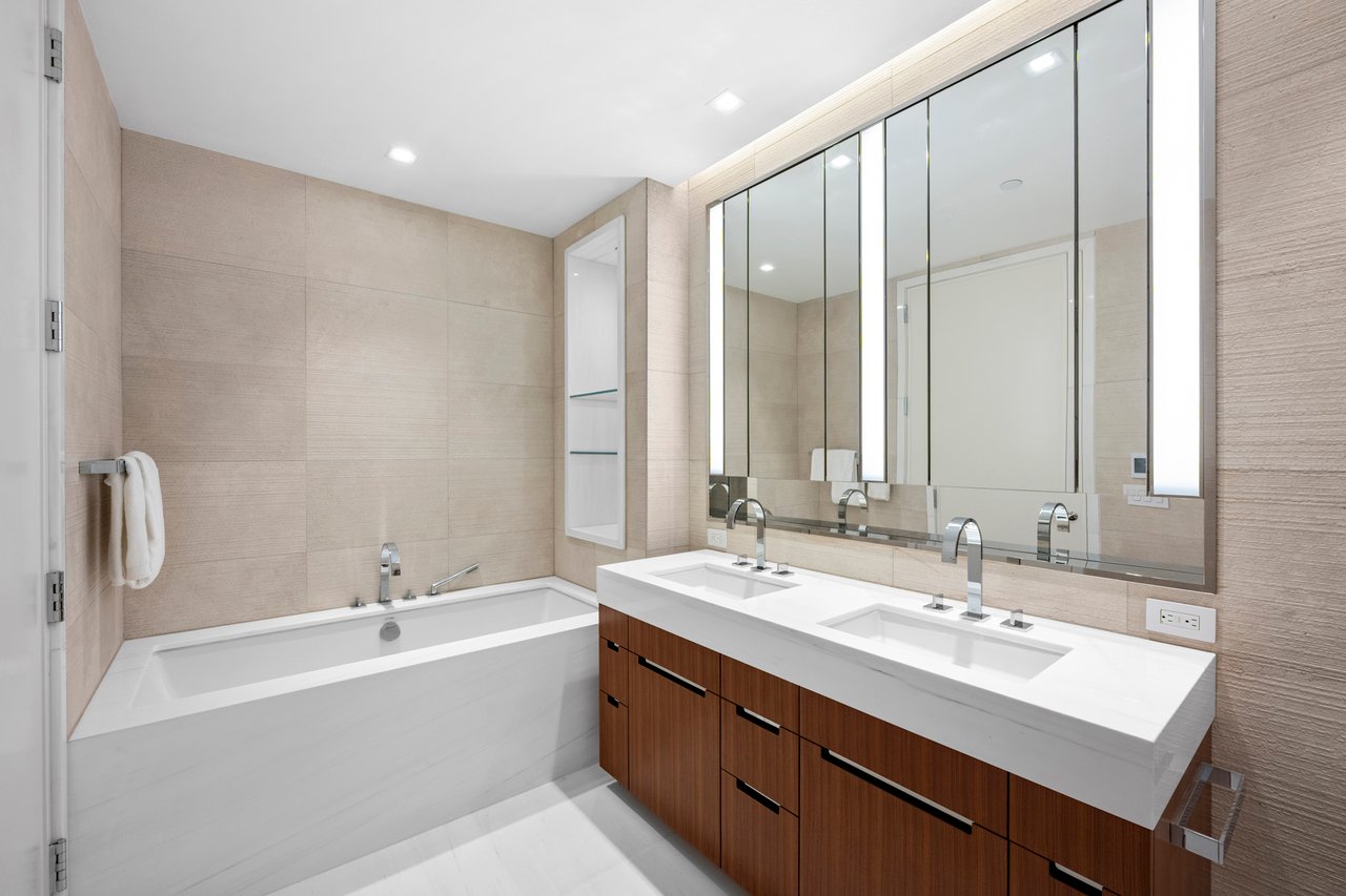 Luxury Manhattan condominium featuring floor-to-ceiling windows, high ceilings, marble flooring, en suite bathrooms, open kitchen, and premium residential finishes.
