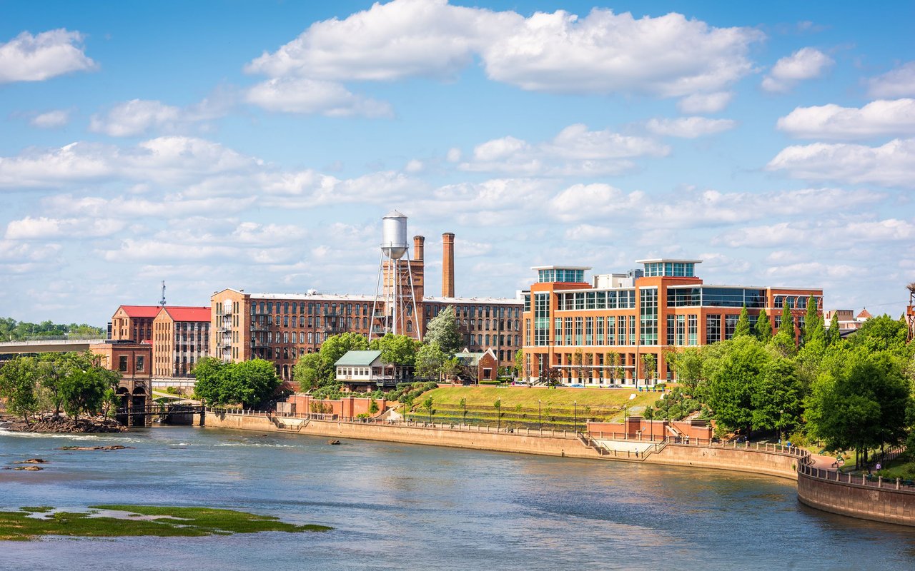 Columbus, Georgia, riverfront with historic brick mills and the river in the foreground.