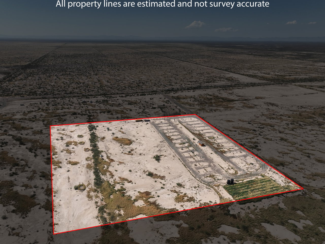 Aerial view of a desert parcel outlined in red, with cleared tracks and sparse scrub.